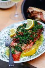 Grilled sea bass with herbal sauce on the gtill