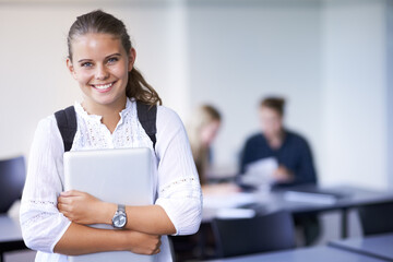 Girl, portrait and teenager with laptop in classroom, back to school and excited for learning. Academy, student and happy face with computer or tech for education, study and kid with a scholarship