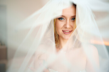 a beautiful, delicate and sexy blonde bride in a veil. Wedding services.
