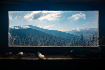 Scenic winter outdoor view through the window of remote mountain shelter