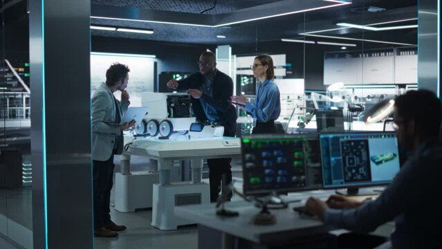 Diverse Team of Industrial Specialists Working on Remotely Controlled Robot. Young Male and Female Engineers in a Lab Discussing an Autonomous AI Delivery Assistant Prototype, Brainstorming