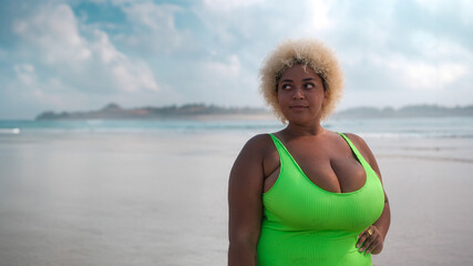 Medium shot banner with empty space and beach view of a young plus size African American woman in a...
