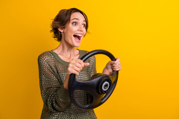 Photo of attractive young woman excited driving steering wheel wear trendy knitwear khaki clothes...