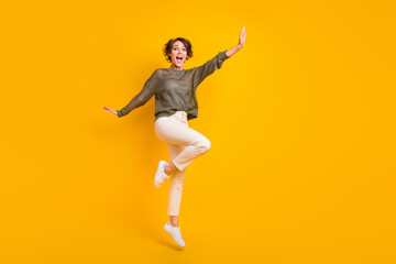 Fototapeta na wymiar Photo of positive glad good mood girl celebrating party presenting empty space isolated on yellow color background