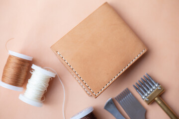 Fototapeta premium Genuine leather bifold money wallet with crafts tool