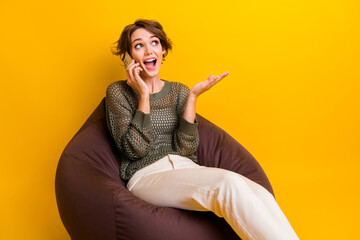Photo of glad lovely girl dressed trendy clothes sitting comfy chair speaking looking empty space...