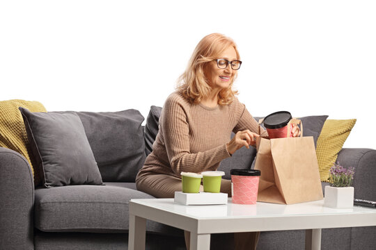 Woman smiling and opening boxes of takeaway food