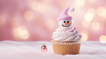  a frosted cupcake with a frosted snowman on top of it and a christmas ornament next to it.