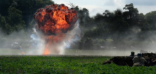 Explosions in controlled manner on simulated second world war battlefield.
