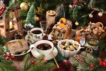 Christmas Eve supper with traditional Polish dishes and pastries on rustic style table