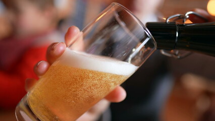 Pouring beer into glass close-up drink, serving refreshing alcholic beverage at restaurant