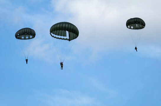 Victory Show. Leicester, UK. Renacted parachute jump with round military style parchutes. 