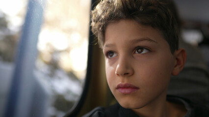 Reflective Ride of Kid with Blank Stare Observing Passing Landscape