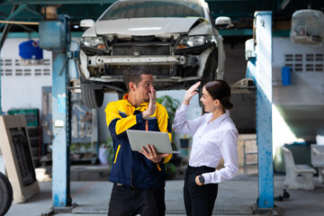 Motor insurance. caucasian man hispanic Accident Inspector Inspect damage car caused by car crash on the road with female customer. Car insurance agent examining car by Claim form clipboard in garage.