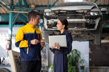 Portrait woman apprentice. Caucasian Female trainee Mechanics Working Underneath Car with male...