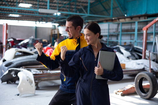 Portrait Woman Apprentice. Caucasian Female Trainee Mechanics Working Underneath Car With Male Instructor At Car Maintenance And Auto Service Garage. Car Maintenance And Auto Service Garage Concept.