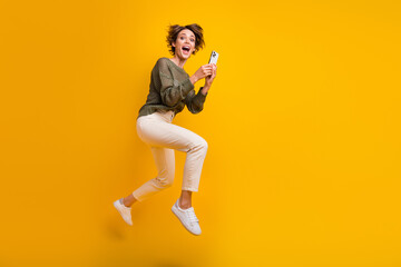 Fototapeta na wymiar Photo of cheerful crazy girl wear stylish clothes hurrying running empty space isolated on yellow color background