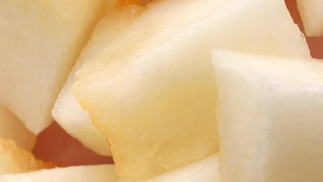 Fresh melon pieces, rotation in circle. slices of ripe juicy melon Turning. selective focus. Vertical video