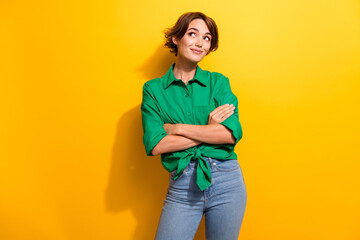 Portrait of pretty manager lady standing confident hold crossed arms looking empty space ad isolated yellow color background