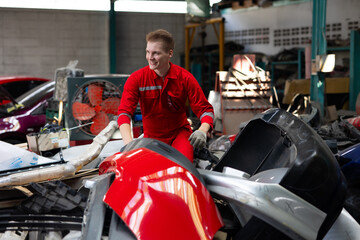 auto mechanic man looking for car spares at workshop or warehouse store. Car maintenance and auto service garage concept