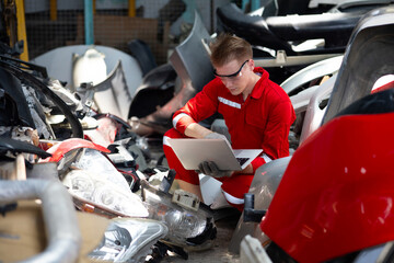 auto mechanic man with laptop computer looking for car spares at workshop or warehouse store. Car...