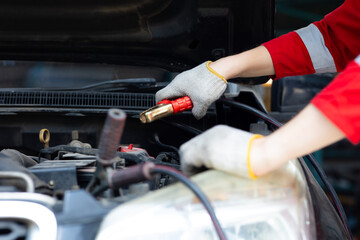 Battery inspection. Battery Capacity Tester Voltmeter. man professional mechanic repairs car...