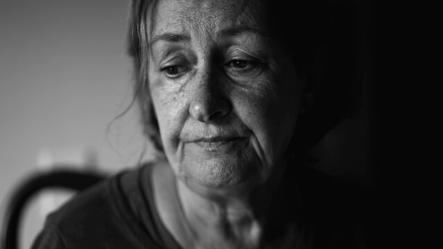 Senior woman struggling with depression, close-up face of dramatic elderly lady in quiet despair, preoccupied anxious emotion