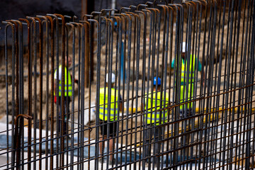 Armature with construction workers in the background during subway building.