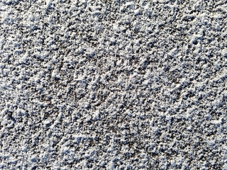 The texture of the snow on the ground or on the asphalt in winter. Winter background for design