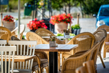 Charming outdoor cafe or bar concept. Inviting scene with stylish table and chairs, perfect for al...