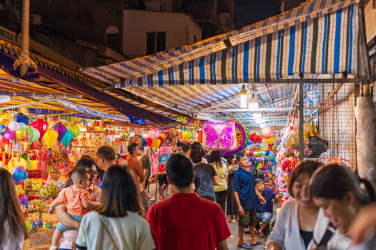 People visit and buy colorful traditional lanterns hanging on Luong Nhu Hoc Street in Vietnam