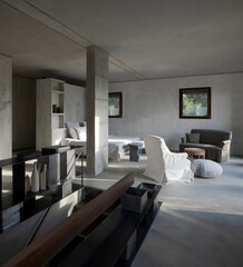 Modern bedroom of a designer farmhouse with a double bed with lots of pillows and large windows that let in lots of natural light.