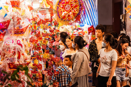 People visit and buy colorful traditional lanterns hanging on Luong Nhu Hoc Street in Vietnam