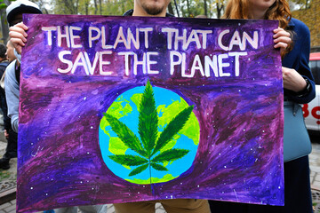 Young people hands holding broadsheet demanding legalization of medical marijuana. Cannabis March