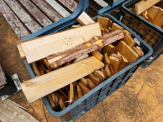A box of discarded wood chips in a blue recycling basket.