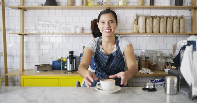Woman, coffee shop and barista, smile, serving customer and cafe in startup, working and store. Service, business owner and server with colleague, worker and apron for restaurant, drink and waitress