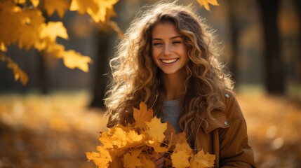 Naklejka premium beautiful young woman with long hair playing outdoors with autumn maple leaves