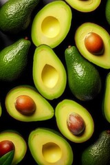Close up of pattern of avocados on black background. Fres fruit concept.