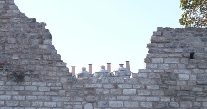 The domes of Topkapi Palace behind the partially destroyed fortress wall. Modern restoration