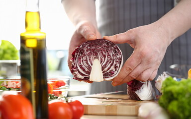 Chef Male Chopping Purple Organic Cabbage Photo. Healthy Vegetable Salad. Hands Holding Half of Fresh Cole on Wooden Board. Home Culinary Kitchen. Dieting Nutrition Horizontal Photography