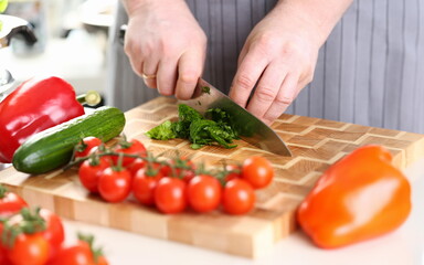 Male Hands Cutting Green Aromatic Sorrel Leaf. Man Cooking Vegetable on Wooden Board at Kitchen. Slicing Ingredient by Sharp Knife. Dieting Product. Organic Food Assortment Horizontal Photography