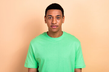 Photo portrait of attractive young man calm face look camera dressed stylish green clothes isolated on beige color background