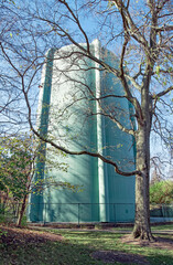 Vintage Water Tower in Dappled Light with Tree