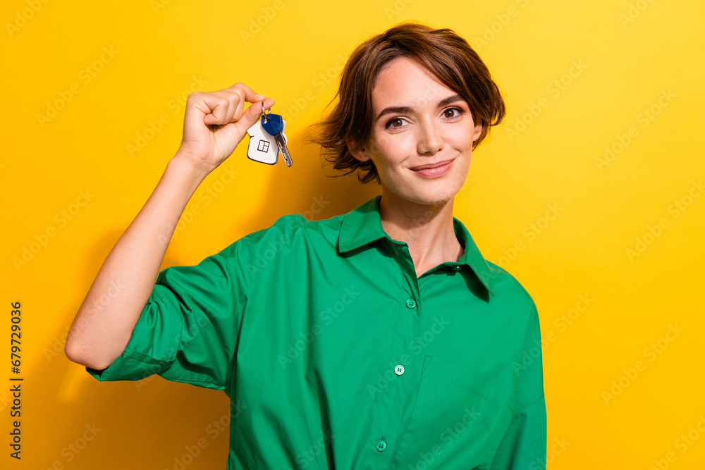 Sticker photo of positive adorable lady wear green shirt smiling rising new apartments keys isolated yellow 