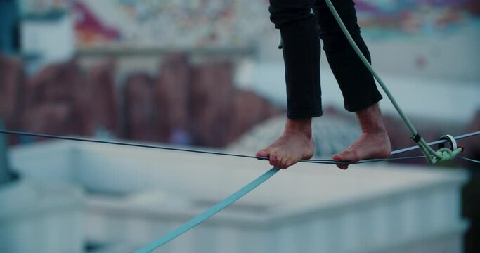 Close up of a barefoot man walking the rope, slacklining, Antalya, Turkey, 4k