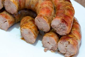 sausage cut, cooked sausage filling. Homemade Pork sausage on the plate.
