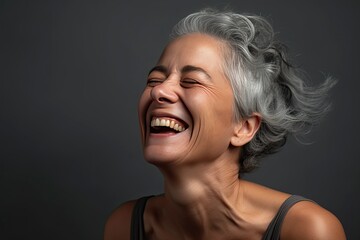 Happy and playful senior woman having fun - Portrait of a beautiful lady above 50 years old with stylish fitness clothes, concepts about senior people and elderly age