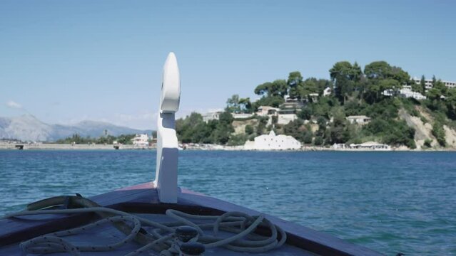 Small tourist boat pov sail on tour to island at Vlacherna monastery on Corfu Island, Greece