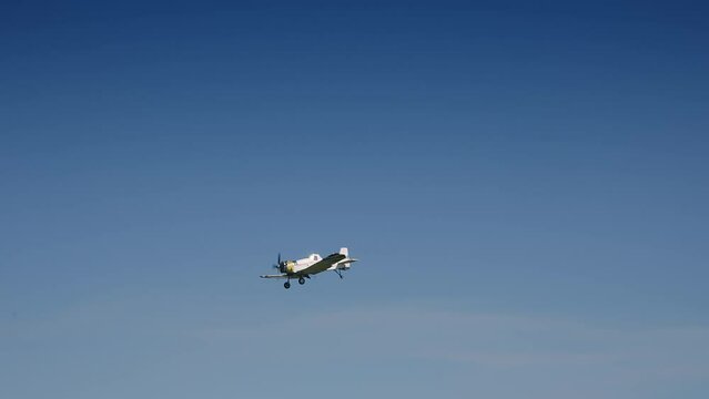 Small propelier tourist plane fly on blue sky aproaching the Corfu island, Greece during landing procedure in slow motion