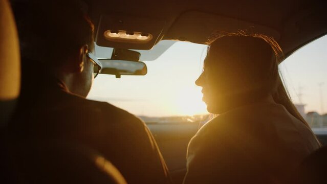 A man and a woman get into the car. The beginning of the journey. The setting sun